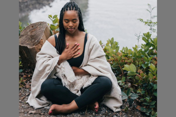 image of woman meditating outside
